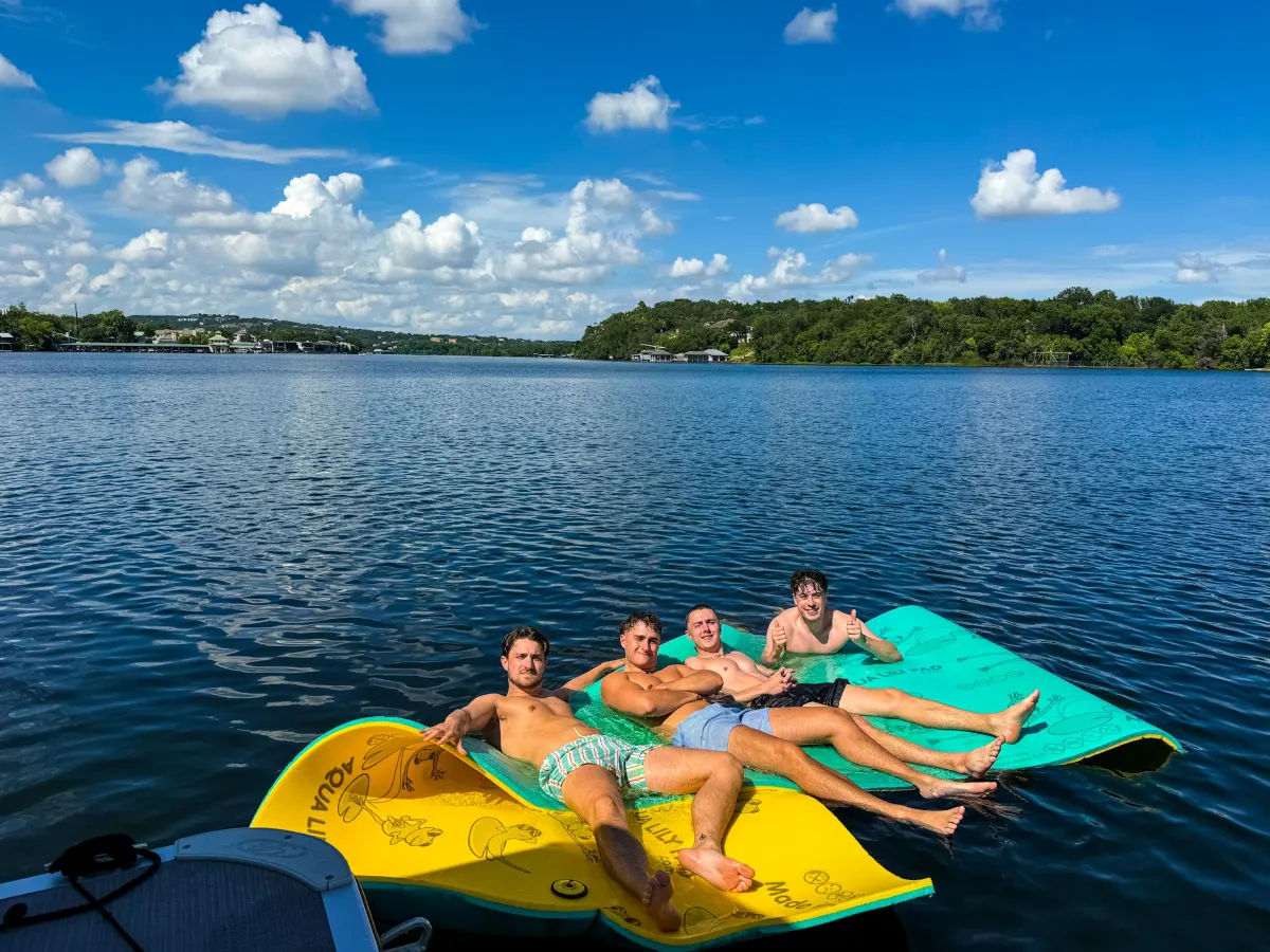 Friends enjoying a bachelor boat party on Lake Austin
