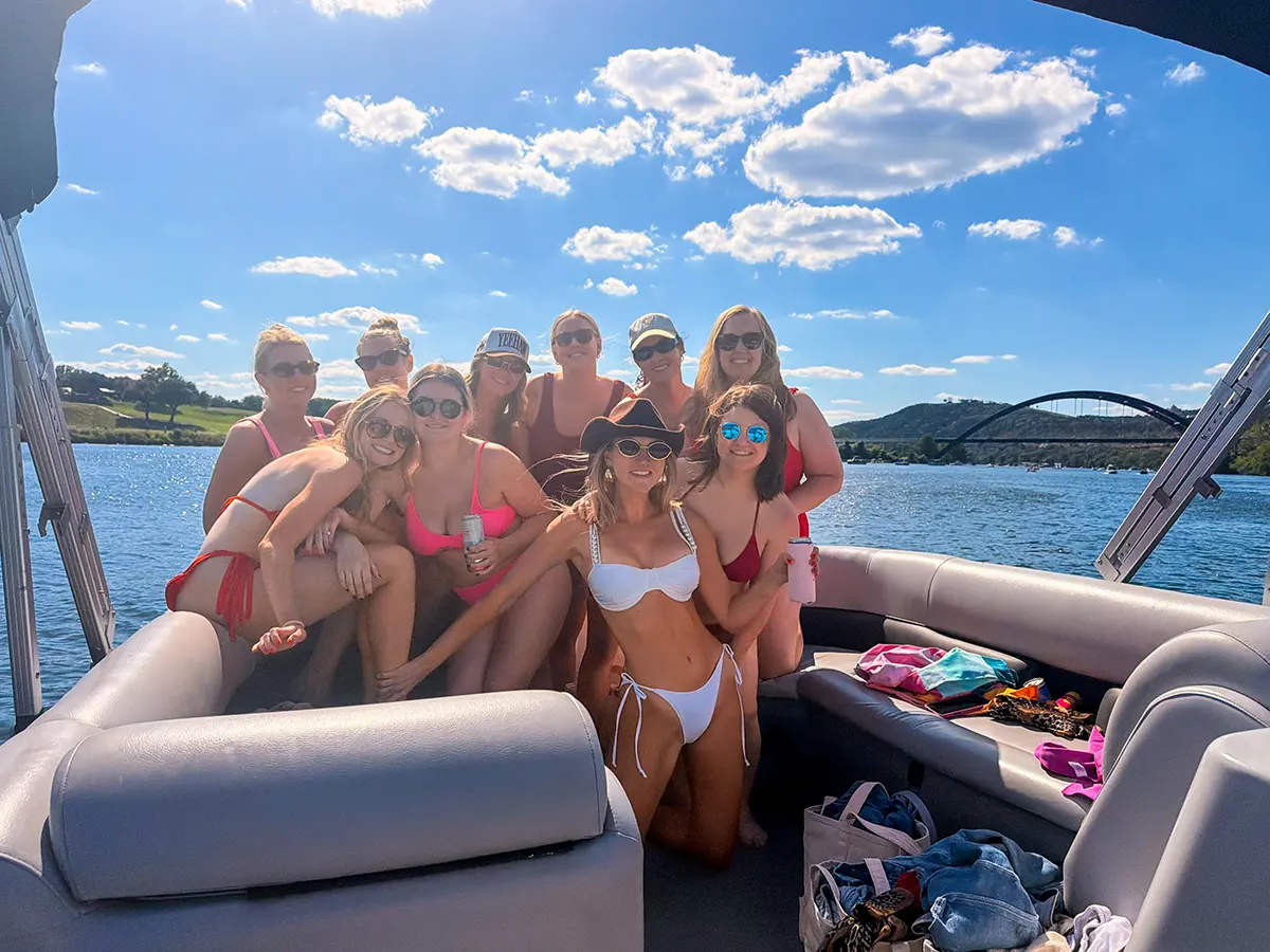 Friends celebrating a bachelorette boat party on Lake Austin